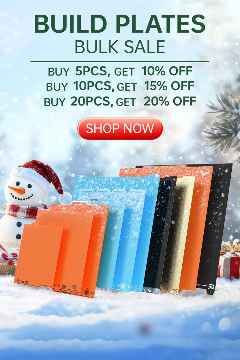 Promotional graphic for bulk purchase of colorful build plates, showing several rectangular sample boards in orange, blue, black, and gold standing in a snowy winter scene with a snowman and pine branch. Large text reads 'BUILD PLATES BULK SALE' with discount offers and a red 'SHOP NOW' button.