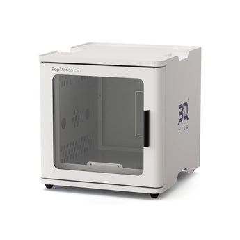 A white PlayStation mini home theater system enclosure with a transparent front window, shown on a clean white background. The side of the unit features a dark blue 'BQ' logo.